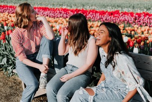 students in front of flowers