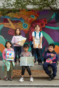 Young school children holding books