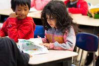 Two young children in a classroom