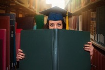 Photo of graduate student holding a book