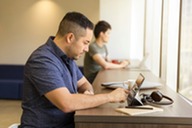 Man using a tablet computer on desk