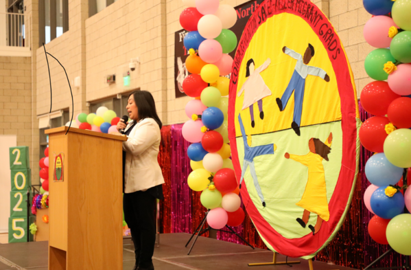 Women on a decorated stage speaking