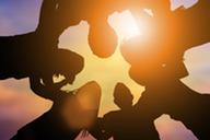 People in a circle with a sunset 