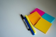 Post-it notes and pens on a table