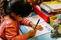 Young girl writing on a piece of paper