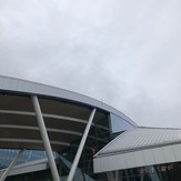 Photo of a building with a metal roof and glass walls