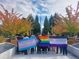 LGBTQ2SIA+ SSP Advisory Group Members hold pride flags at Oregon capitol