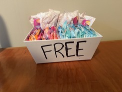 a basket marked "free" full of menstrual products