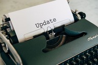 Typewriter with paper showing the word “update.”