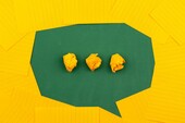 Green and yellow paper designed to look like a speech bubble