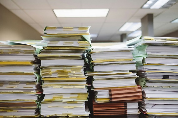 stacks of paper files standing haphazardly 