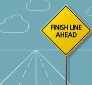 Road with road sign saying finish line ahead