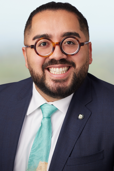 smiling man wearing glasses in a suit