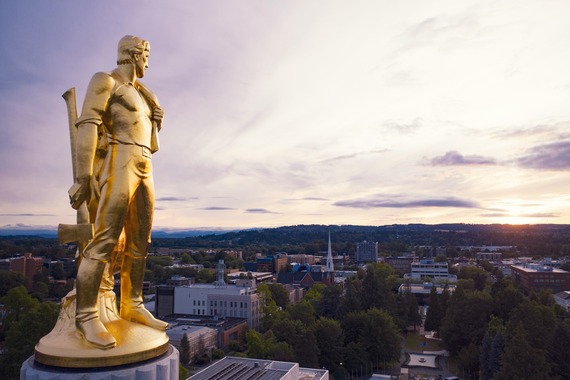 Golden statue turning to the right across Salem landscape