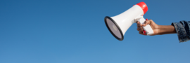 a hand holding a megaphone on the right side of the screen