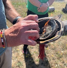 Medicine herbs burning in abalone shell.