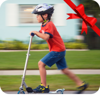 photo of a young boy riding a scooter
