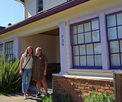 Andrea Garcia and Ashley Teeters in front of the home purchased by L.G.S.
