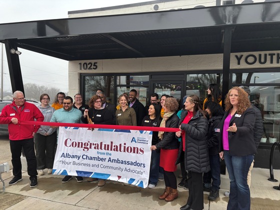 big group outside building cutting ribbon