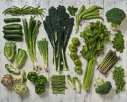 A variety of green vegetables organized on a table