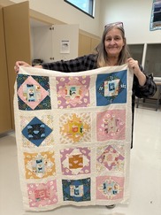 OSH Junction City patient holds a fabric collage she crafted.