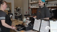 A Fresh Start Cafe employee helps a customer