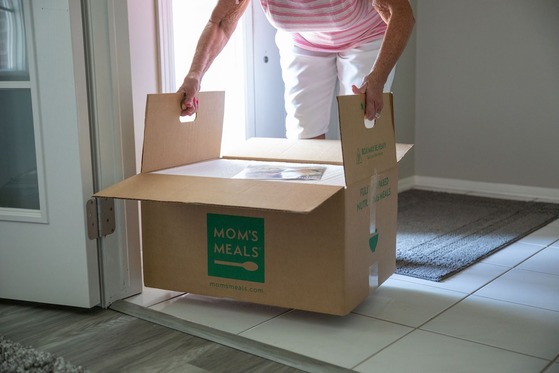 Box of food with "Mom's Meals" on the side