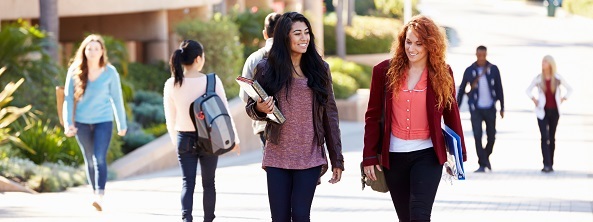 Students walking on campus sidewalk
