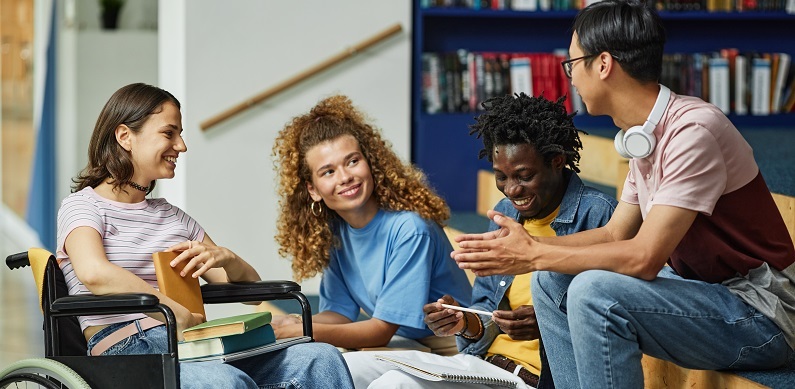 Four students in a library talking