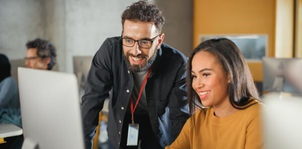 Two students at a laptop - stock image
