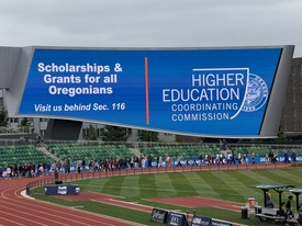 OSAC advertisement at athletic field graduation walk
