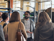 Tech Consortium members listen to OSU student during tour of OSU Robotics Lab. 
