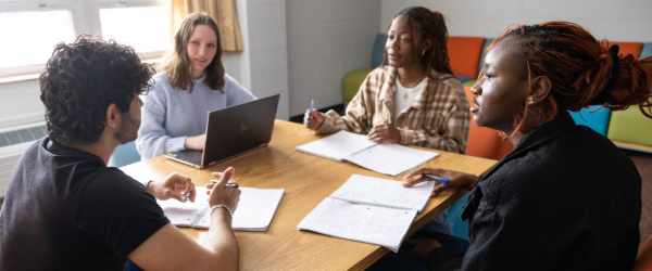 Four students at a table, Photo by Allison Shelley/Complete College Photo Library