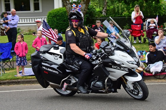Motor Officer on a motorcycle looking back over his shoulder.