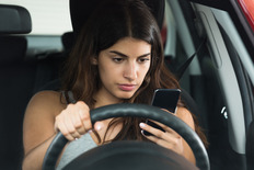 Woman Using Her Phone While Driving