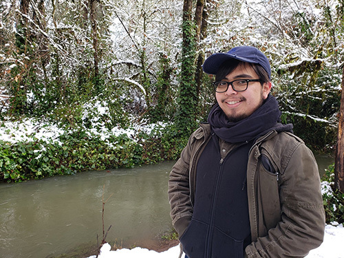 Salomon Hernandez stands by a creek in winter