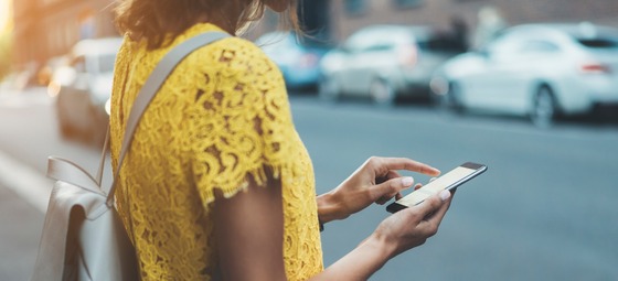 Woman Distracted by Her Phone Getting Ready to Cross the Street