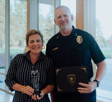 Chaplain Libby Spotts and Chief Jim Coleman Standing with Award