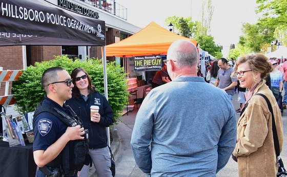 Hillsboro Police personnel talking with community members at Saturday Market