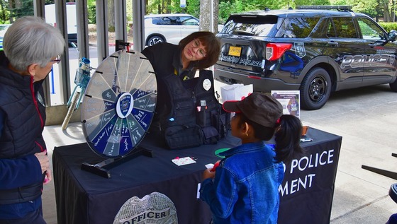 Child spinning a wheel for a prize at Dia del Nino