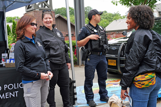 Hillsboro Police Officer and Staff Talking with a Woman at the Police Department Booth