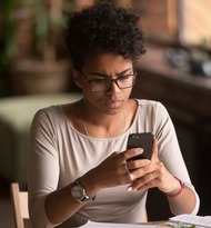 Concerned Woman Looking at Her Phone