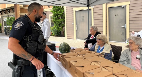 Officer picking up a lunch from the residents at The Springs at Tanasbourne