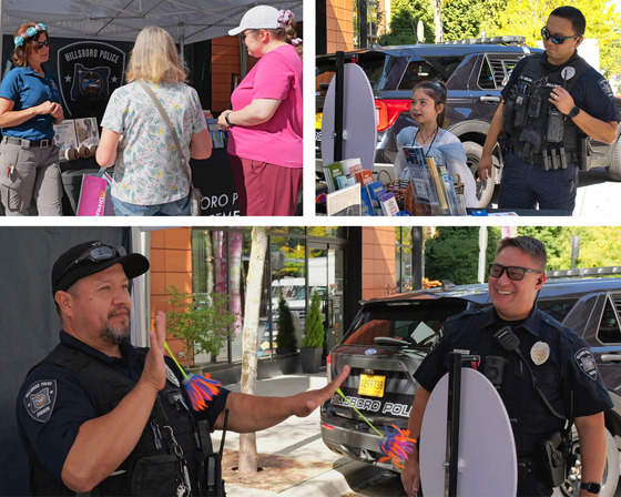 Officer playing with kid toy; Officer next to young girl spinning a wheel to learn about safety; Hillsboro Police employee talking to two ladies