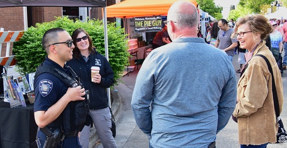 Hillsboro Police Officer and Staff Member Talking to Two People at Saturday Market