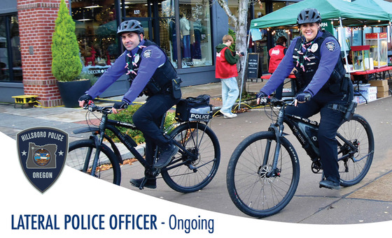 Two Police Officers Riding Bicycles - Lateral Police Officer - Ongoing 