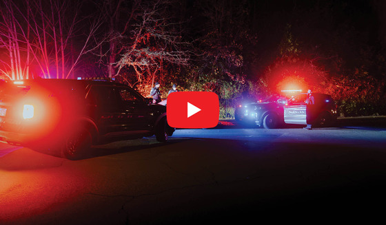 Two Police Vehicles with Their Emergency Lights On