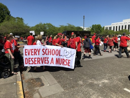 March on the Capitol for Student Success Act and signs for student health
