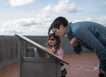 Visitors read the interpretive panels on top of the Capitol