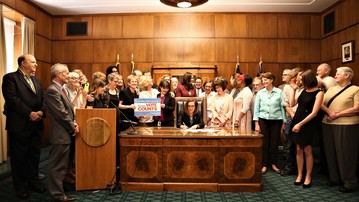 Govenor Kate Brown signing SB 870 with the support of Senator Riley and others.